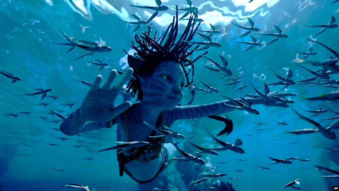 This image released by 20th Century Studios shows Trinity Bliss, as Tuk, in a scene from "Avatar: The Way of Water."