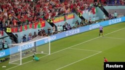 Portuguese forward Cristiano Ronaldo scores a penalty against Ghana in their opening Group H match at the 2022 FIFA World Cup