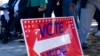 People head to the polls in the runoff election between Democratic Senator Raphael Warnock and Republican challenger Herschel Walker, in Atlanta, Nov. 27, 2022. 