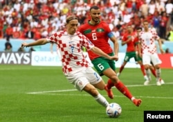 Croatia's Lovro Majer in action with Morocco's Romain Saiss during the Morocco v Croatia World Cup match at Al Bayt Stadium, Al Khor, Qatar, Nov. 23, 2022.