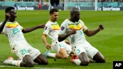 Senegal's Kalidou Koulibaly, right, celebrates with teammates scoring his side's second goal during the World Cup group A soccer match between Ecuador and Senegal, at the Khalifa International Stadium in Doha, Qatar, Nov. 29, 2022.
