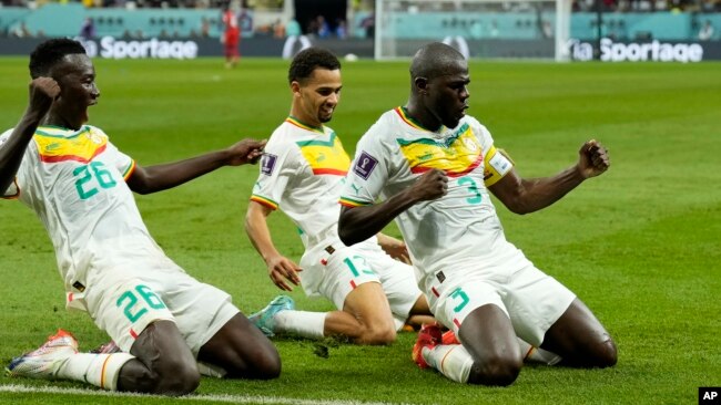 Senegal's Kalidou Koulibaly, right, celebrates with teammates scoring his side's second goal during the World Cup group A soccer match between Ecuador and Senegal, at the Khalifa International Stadium in Doha, Qatar, Nov. 29, 2022.