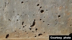 Holes are seen in the wall of a building after a grenade attack, at Dzaleka refugee camp, Malawi, Dec. 14, 2022. (Photo courtesy of eyewitness at Dzaleka refugee camp)