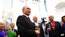 Russian President Vladimir Putin makes a toast at an ceremony at the Kremlin's St. Catherine Hall in Moscow, Dec. 20, 2022.