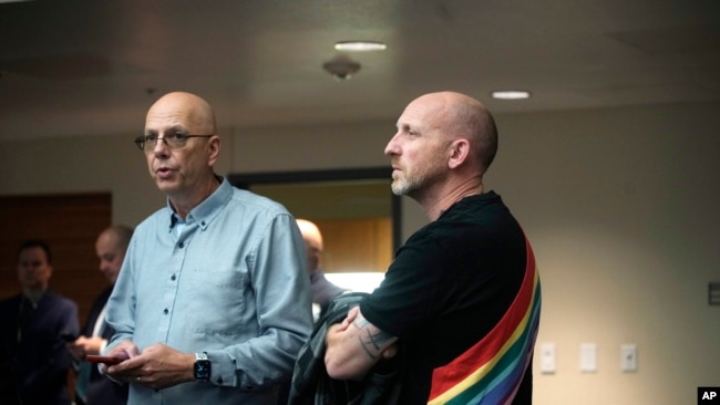 Co-owners of Club Q, Matthew Haynes, left, and Nic Grezcka look on during a news conference about the mass shooting at their bar, Monday, Nov. 21, 2022, in Colorado Springs, Colo.