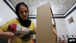 Iraqi carpenter Nour al-Janabi works at her home furniture workshop in Baghdad's Abu Dsheer area, on Nov. 13, 2022.