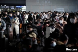 Warga di stasiun kereta api menjelang perayaan Festival Musim Semi Tahun Baru Imlek, saat wabah COVID-19 masih menghantui, di Shanghai, China, 16 Januari 2023. (Foto: REUTERS/Aly Song)