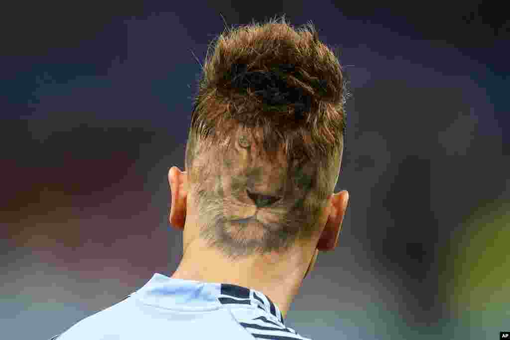 Uruguay's goalkeeper Sebastian Sosa sports a haircut showing the image of a lion during the warm up before the World Cup group H soccer match between Ghana and Uruguay, at the Al Janoub Stadium in Al Wakrah, Qatar.