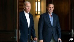 FILE - President Joe Biden and his son Hunter Biden are seen leaving a church service in Johns Island, South Carolina, Aug. 13, 2022, during a family vacation.