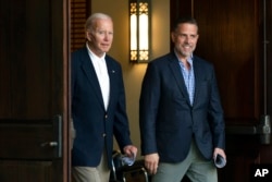 FILE - President Joe Biden and his son Hunter Biden are seen in Johns Island, S.C., Aug. 13, 2022.