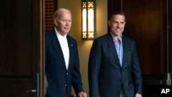 FILE - President Joe Biden and his son Hunter Biden are seen in Johns Island, S.C., Aug. 13, 2022.