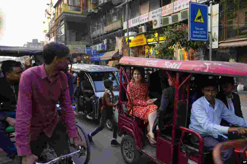 German Foreign Minister Annalena Baerbock rides on an e-rickshaw during her tour of Chandni Chowk, in the old quarters of New Delhi, India.