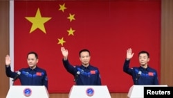 Astronauts Fei Junlong, Deng Qingming and Zhang Lu attend a news conference before the Shenzhou-15 spaceflight mission to build China's space station, at Jiuquan Satellite Launch Center, near Jiuquan, Gansu province, China November 28, 2022. (cnsphoto via REUTERS )