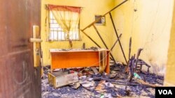 FILE – Offices belonging to Nigerian Independent National Electoral Commission are burnt after an attack in Imo state, Dec. 12, 2022