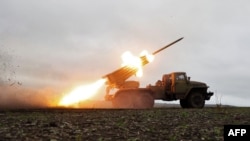FILE - A BM-21 'Grad' multiple rocket launcher fires towards Russian positions on the front line near Bakhmut, Donetsk region, Ukraine, Nov. 27, 2022,