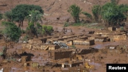 FILE - The Bento Rodrigues district is pictured covered with mud after a dam owned by Vale SA and BHP Billiton Ltd burst in Mariana, Brazil, Nov. 6, 2015.