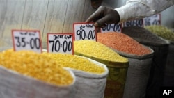 A shopkeeper arranges price tags on pulses at a wholesale market in the old quarter of New Delhi (File)