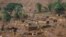 FILE - The Bento Rodrigues district is pictured covered with mud after a dam owned by Vale SA and BHP Billiton Ltd burst in Mariana, Brazil, Nov. 6, 2015.