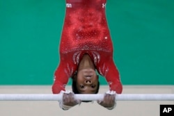 United States' Gabrielle Douglas trains on the uneven bars ahead of the 2016 Summer Olympics in Rio de Janeiro, Brazil, Aug. 4, 2016.