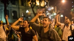 Protestors shout slogans at riot police, asking for no violence, during an anti-government demonstration in Rio de Janeiro, Brazil, Thursday, June 20, 2013. 