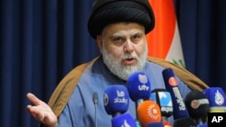 FILE - Powerful Shiite cleric Muqtada al-Sadr speaks during a press conference in Najaf, Iraq, Nov. 18, 2021.