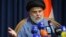 FILE - Powerful Shiite cleric Muqtada al-Sadr speaks during a press conference in Najaf, Iraq, Nov. 18, 2021.