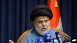 FILE - Powerful Shiite cleric Muqtada al-Sadr speaks during a press conference in Najaf, Iraq, Nov. 18, 2021.