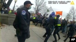 This image from video from a police worn body camera from the Jan. 6 riot at the US Capitol, was played as a committee exhibit as the House select committee investigating the the Jan. 6 attack on the U.S. Capitol, held a hearing June 9, 2022.