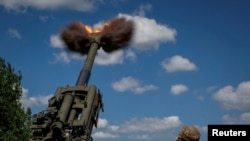 Ukrainian service members fire a shell from a M777 Howitzer near a frontline, as Russia's attack on Ukraine continues, in Donetsk Region, Ukraine, June 6, 2022. 