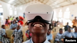 FILE: Francis Mwangi, 13, uses an Oculus virtual reality (VR) headset, to virtually visit Buckingham Palace during the celebration of Britain's Queen Elizabeth's Platinum Jubilee, in Nyeri, Kenya. Taken 6.2.2022