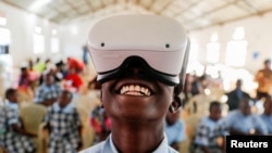 FILE: Francis Mwangi, 13, uses an Oculus virtual reality (VR) headset, to virtually visit Buckingham Palace during the celebration of Britain's Queen Elizabeth's Platinum Jubilee, in Nyeri, Kenya, June 2, 2022.