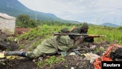 FILE - DRC soldiers take their position following renewed fighting near Congo's border with Rwanda, outside Goma in the DRC's North Kivu province, May 28, 2022. U.N. experts claim that the M23 rebel group has had support in the region from Rwandan troops.
