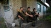 Ukrainian servicemen rest on their position not far from the Ukrainian town of Chuguiv, in Kharkiv region on June 9, 2022.