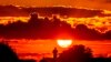 A man runs along a small road as the sun rises on the outskirts of Frankfurt, Germany, May 8, 2022.