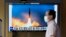 FILE: A TV screen showing a news program reporting about Sunday's North Korean missile launch with file image, is seen at a train station in Seoul, South Korea, June 5, 2022. 