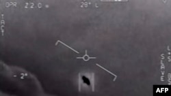 FILE - In this photo taken on April 28, 2020 this video grab image courtesy of the US Department of Defense shows part of an unclassified video taken by Navy pilots that have circulated for years showing interactions with "unidentified aerial phenomena.