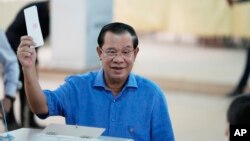 Cambodian Prime Minister Hun Sen, of the Cambodian People's Party (CPP), casts his vote at a polling station in Takhmua in Kandal province, southeast of Phnom Penh, June 5, 2022. 