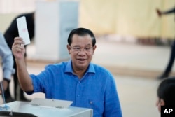 Cambodian Prime Minister Hun Sen, of the Cambodian People's Party (CPP), casts his vote at a polling station in Takhmua in Kandal province, southeast of Phnom Penh, June 5, 2022.