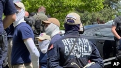 FILE - Authorities arrest members of the white supremacist group Patriot Front near an Idaho pride event, June 11, 2022, after they were found packed into the back of a U-Haul truck with riot gear.