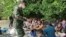 (မှတ်တမ်း ပုံဟောင်း) In this photo released by the Royal Thai Navy taken June 4, 2022, members of the Thai navy help Rohingya refugees found on Koh Dong Island in Satun province, southern Thailand.