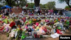 FILE PHOTO: Flowers, toys, and other objects to remember the victims of the deadliest U.S. school mass shooting in nearly a decade, resulting in the death of 19 children and two teachers, are pictured at the Robb Elementary School in Uvalde, Texas.