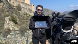 FILE - A handout image released by French 24-hour news TV channel BFM TV on May 30, 2022, shows the channel's French journalist Frederic Leclerc-Imhoff working at an undisclosed location.