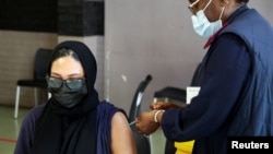 FILE - A healthcare worker administers the coronavirus disease (COVID-19) vaccine to a pregnant woman, in Johannesburg, South Africa, Dec. 9, 2021.