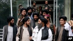 FILE - Mullah Abdul Ghani Baradar, acting deputy prime minister of the Afghan Taliban's caretaker government, center, and other Taliban officials attend a ceremony marking the 9th anniversary of the death of Mullah Mohammad Omar, Apr. 24, 2022.