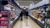 FILE - Customers shop at a grocery store in Mount Prospect, Ill., United States on April 1, 2022.