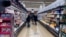 FILE - Customers shop at a grocery store in Mount Prospect, Ill., United States on April 1, 2022.