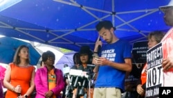 David Hogg, third from right, Parkland school shooting survivor and co-founder of "March for Our Lives," pauses as he speaks during a rally outside Sen. Marco Rubio's Miami office calling for gun reform, June 3, 2022, in Miami.