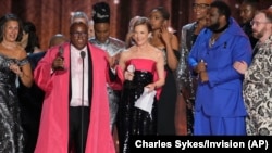 Michael R. Jackson, second left, accepts the award for best new musical for "A Strange Loop" at the 75th annual Tony Awards, June 12, 2022, at Radio City Music Hall in New York.