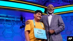 Actor LeVar Burton stands with Surya Kapu, 13, from South Jordan, Utah, during the Scripps National Spelling Bee, June 2, 2022, in Oxon Hill, Md.