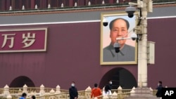 Security officers stand guard near Tiananmen Gate before the closing session of China's National People's Congress (NPC) at the Great Hall of the People in Beijing, March 11, 2022.